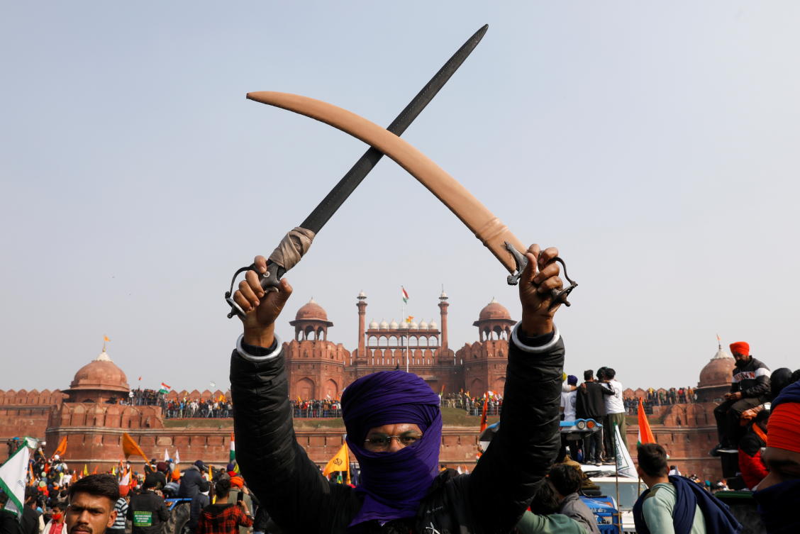 A farmer holds a sword during a protest against farm laws introduced by the government, at the historic Red Fort in Delhi, India, January 26, 2021. REUTERS/Adnan Abidi TPX IMAGES OF THE DAY