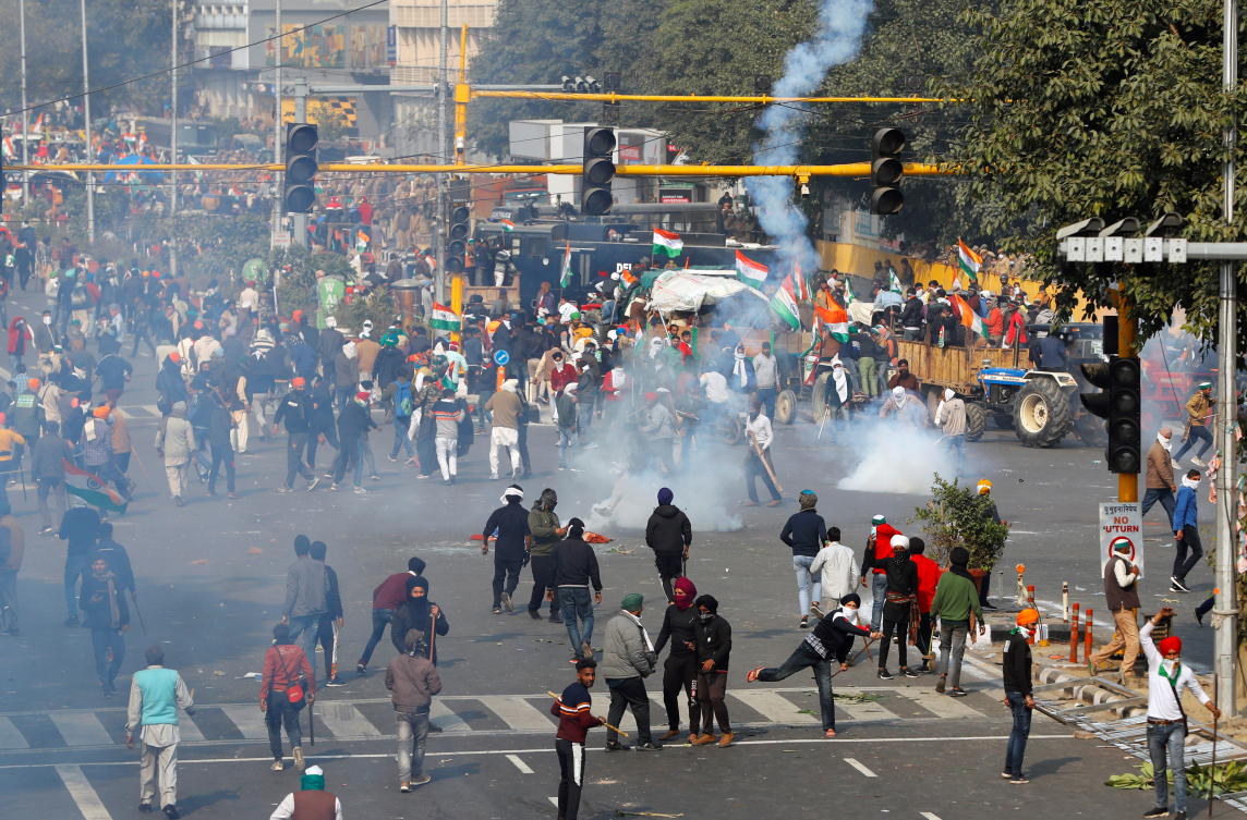 Police officers use tear gas during a protest against farm laws introduced by the government, in New Delhi, India, January 26, 2021. REUTERS/Adnan Abidi