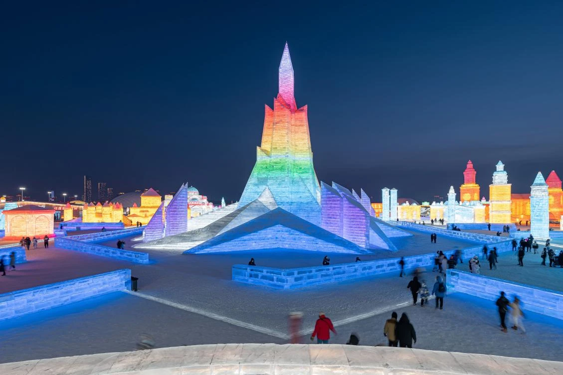 People look at ice sculptures at the Harbin Ice and Snow Festival in Harbin, in northeastern China's Heilongjiang province on January 5, 2021. - China OUT / AFP / STR