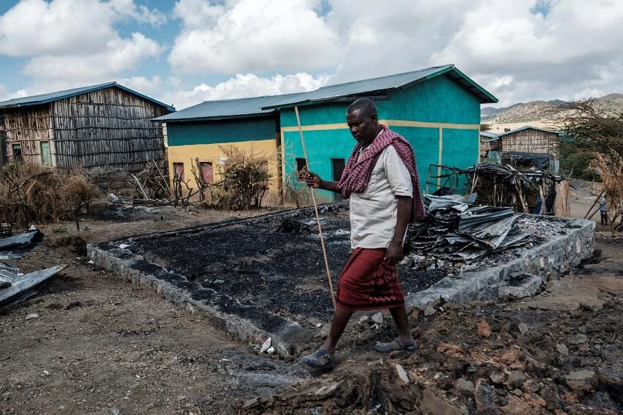 Addis Sissay, 49, walks in front of his destroyed house in the village of Bisober, in Ethiopia's Tigray region on December 9, 2020. (File/AFP)
