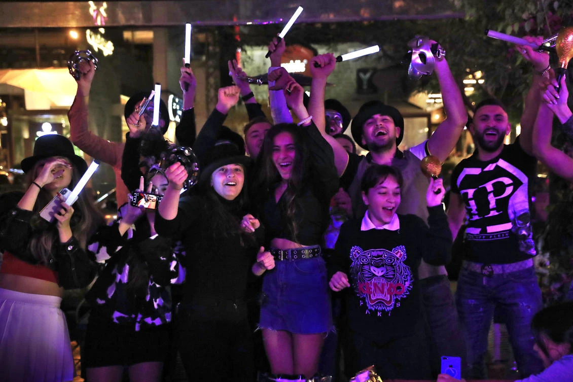 Lebanese people celebrate the New Year in Beirut, early Friday, Jan. 1, 2021. (AP)