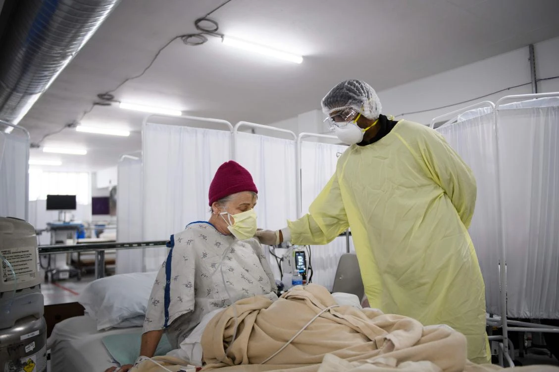 In this file photo taken on December 16, 2020 Dr. Bijay Sah attends to a patient in the Covid-19 alternative care site, built into a parking garage, at Renown Regional Medical Center in Reno, Nevada. (AFP)