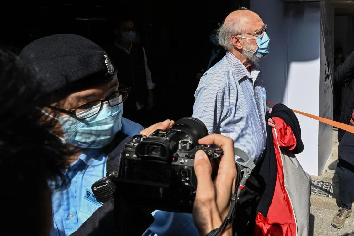 John Clancey, a solicitor with law firm Ho Tse Wai and Partners that is known for taking on human rights cases, is led away by police after he was arrested under a new national security law in Hong Kong on Jan. 6, 2021. (AFP)