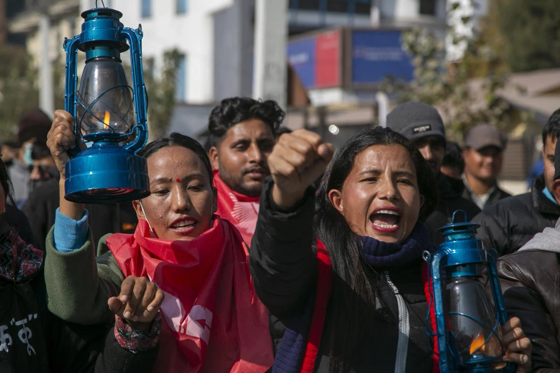 Protesters carrying lanterns, a mark of protest, march near Nepal’s parliament building in Katmandu on Jan. 6, 2021. (AP)