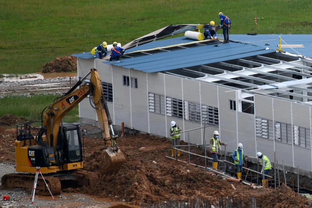 Workers construct a new quick-build dormitory for foreign workers in Singapore. (File/AFP)