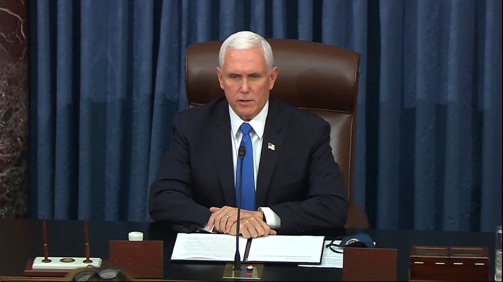 In this image from video, Vice President Mike Pence speaks as the Senate reconvenes after protesters stormed into the U.S. Capitol on Wednesday, Jan. 6, 2021. (Senate Television via AP)