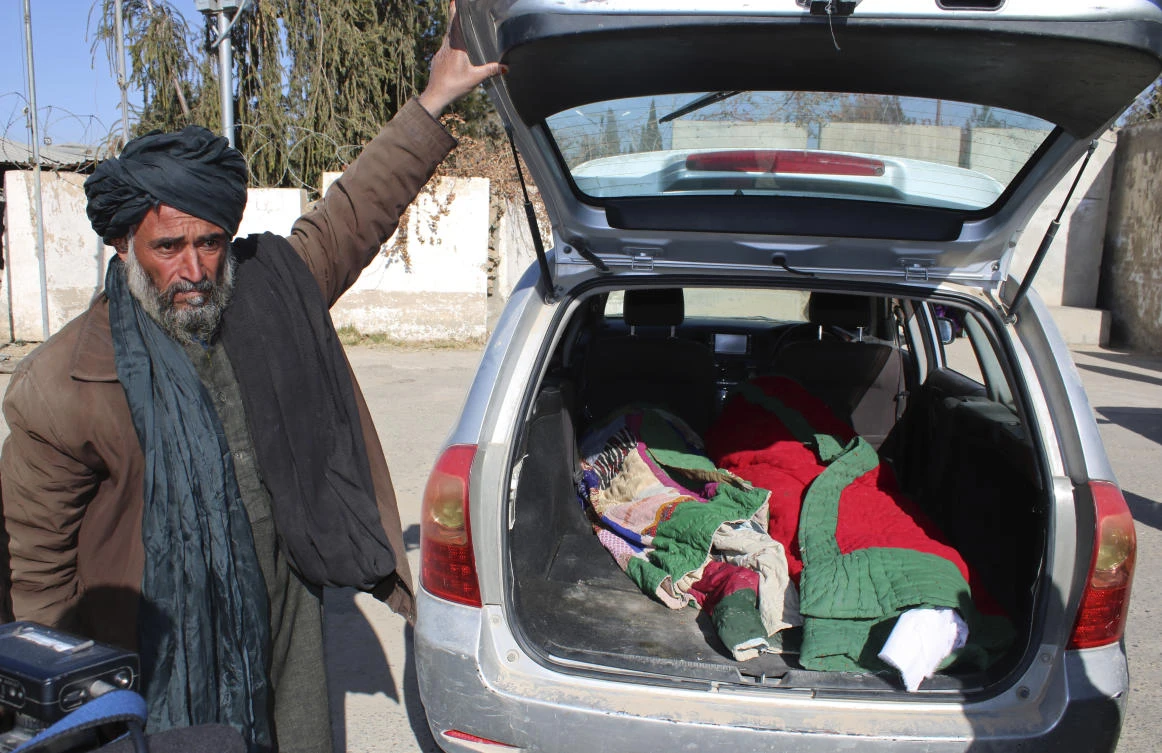 Covered bodies of civilians lie in the back of a vehicle in front of the Helmand Provincial Government Office in Lashkar Gah, south of Kabul on Jan. 7, 2021. (AP)