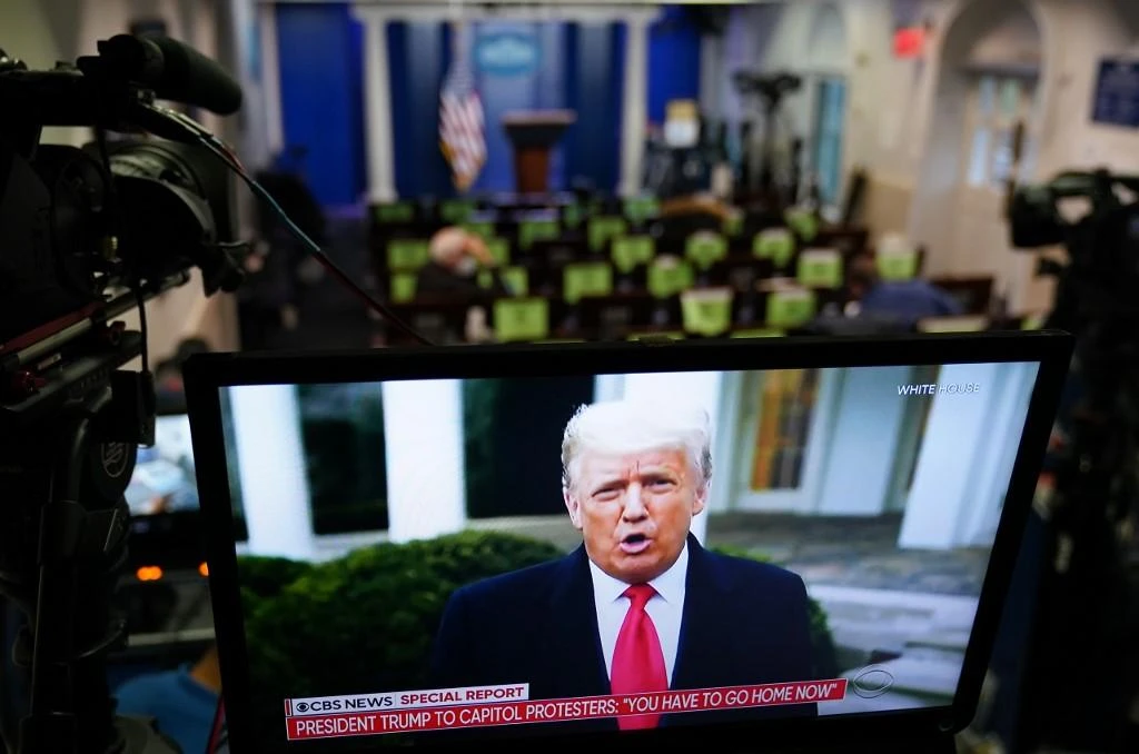 US President Donald Trump is seen on TV from a video message released on Twitter on Jan. 6, 2021. (AFP)