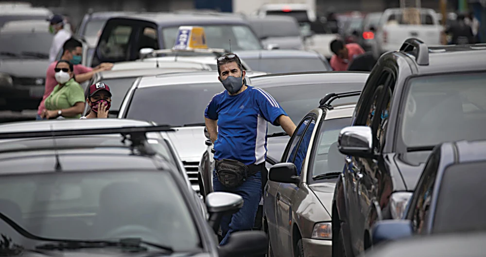 People wait in a line near a gas station to fill their tanks in Caracas. (AP/File)