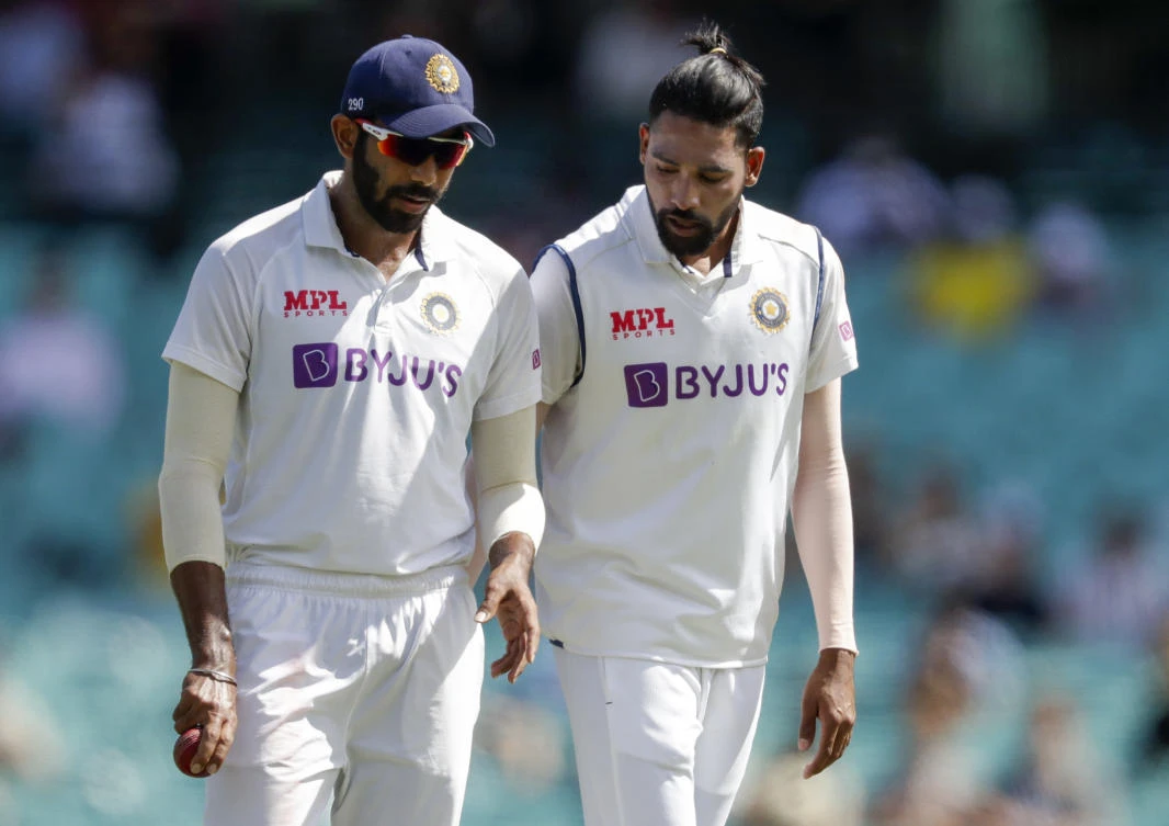 Indian bowler Jasprit Bumrah, left, and Mohammed Siraj talk during play on day one of the third cricket test between India and Australia at the Sydney Cricket Ground, Sydney, Australia, Thursday, Jan. 7, 2021. (AP)