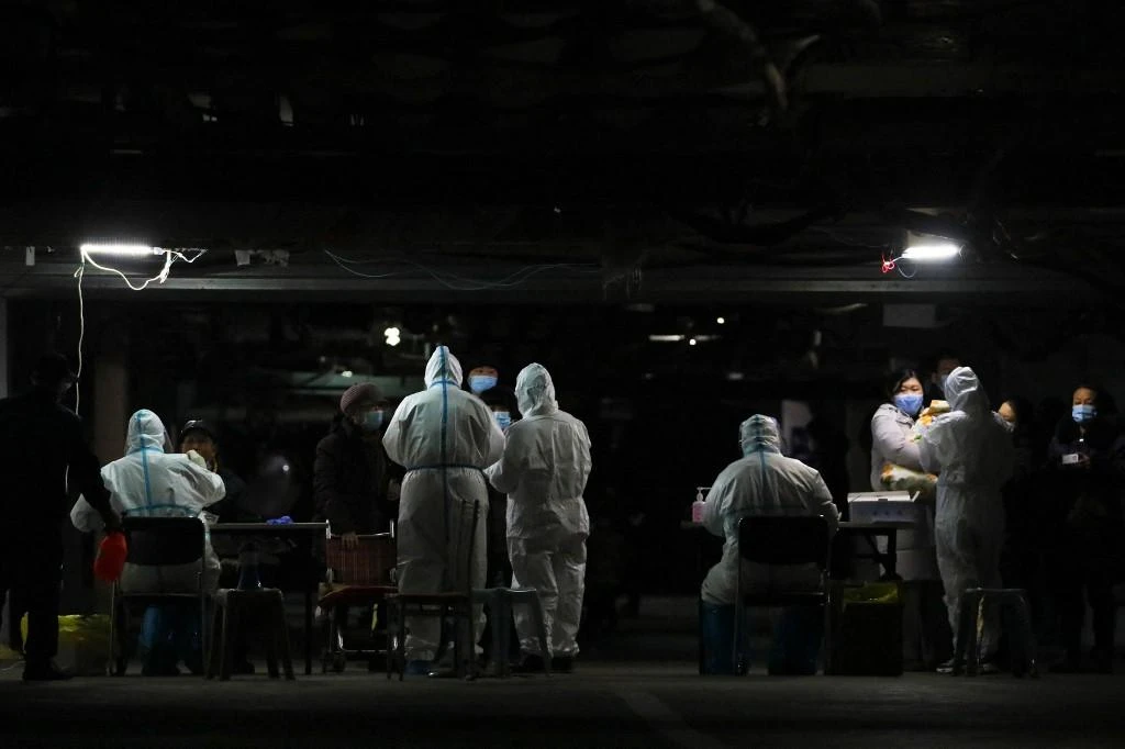 Residents undergo COVID-19 coronavirus tests at the basement of a residential compound as part of a mass testing programme following new cases of the virus emerging in Shijiazhuang, in central Hebei province on Jan. 12, 2021. (File/AFP)