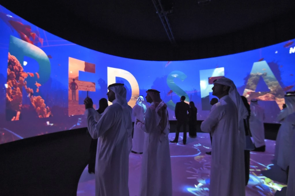 Above, participants watch a movie advertising Saudi’s Red Sea project on the sidelines of the three-day Future Investment Initiatives conference in Riyadh, on Oct. 25, 2017. (AFP file photo)