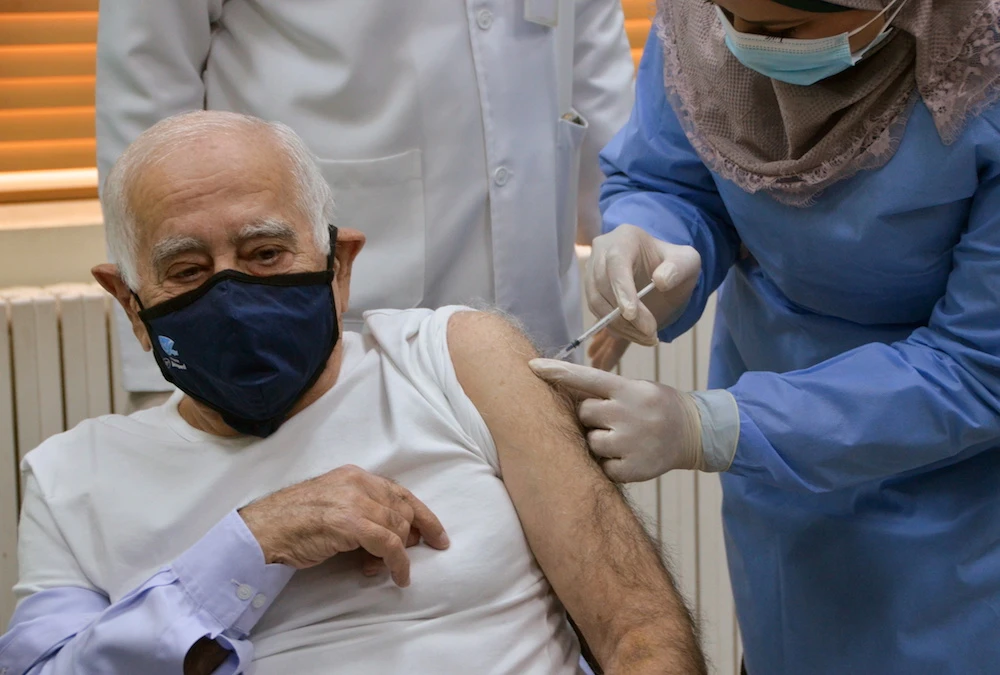 Dawood Hananiah, receives the first COVID-19 vaccine in Jordan, at a medical center in Amman. (Reuters)