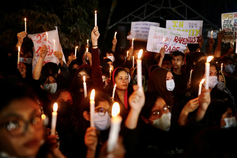 Women activists join in a candlelight protest demanding justice for the recent rape incident in Dhaka on January 9, 2021. Bangladeshi women are also protesting a high court ruling barring them from becoming Muslim marriage registrars. (REUTERS/Mohammad Ponir Hossain)