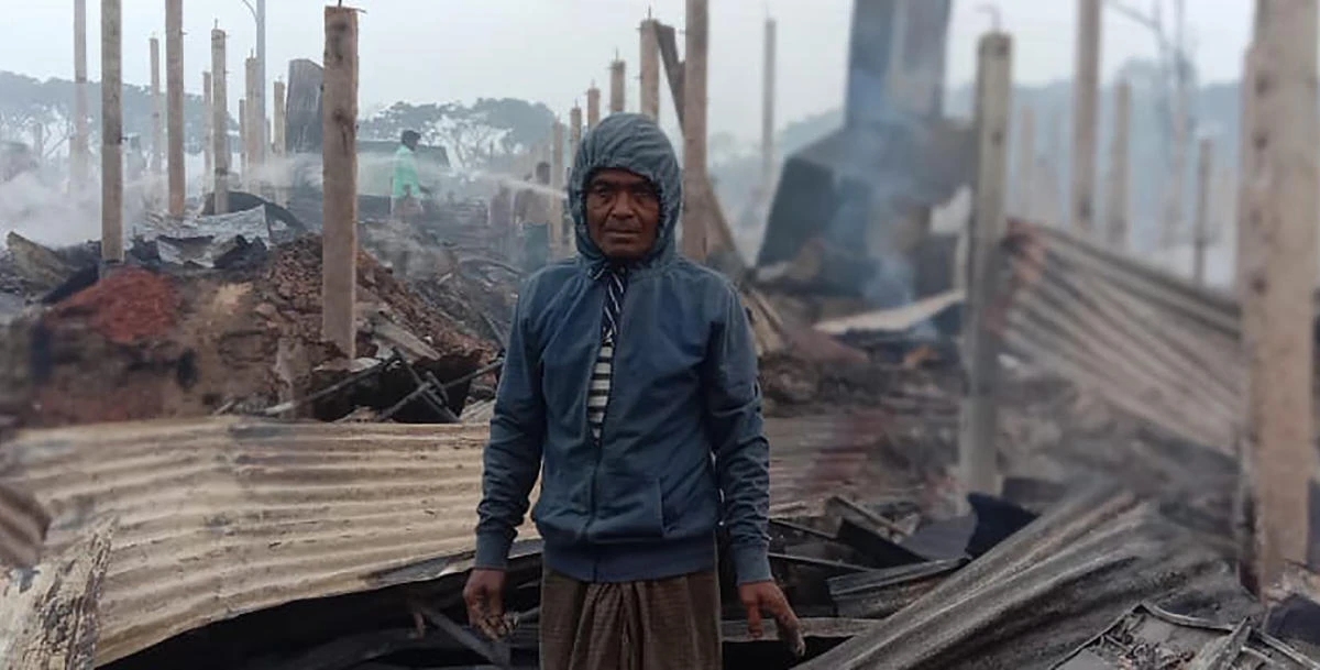 A Rohingya refugee stands. by the charred remains after a fire broke out in Nayapara Camp in Cox's Bazar district, Bangladesh, Thursday, Jan. 14, 2021. (AP)