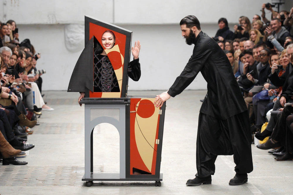 A magician performs with a model who presents a creation by Indian designer Manish Arora as part of his Fall-Winter 2011/2012 women's ready-to-wear fashion collection during Paris Fashion Week March 3, 2011. (REUTERS/Benoit Tessier/File Photo)