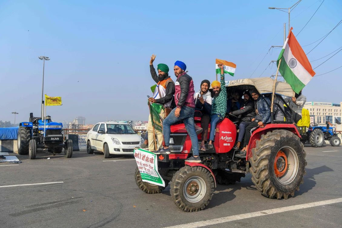 Protesting farmers shout slogans near police barricades as they continue to protest along a blocked highway against the central government's recent agricultural reforms, at the Gazipur Delhi-Uttar Pradesh state border, in Ghaziabad on Jan. 12, 2021. (File/AFP)