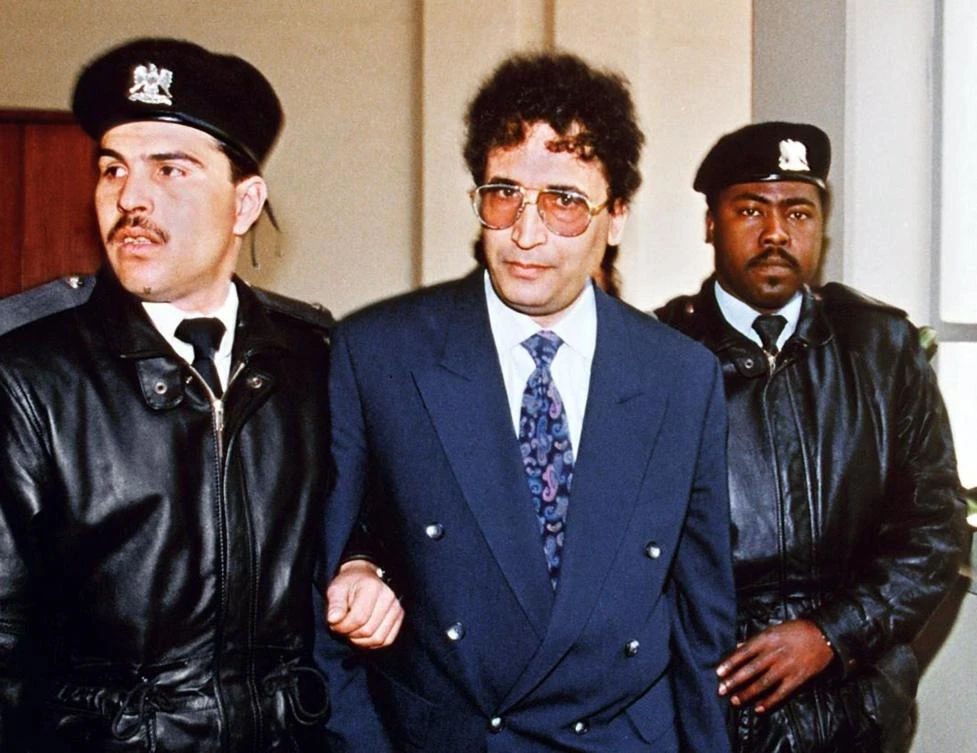 Above, Lockerbie bomber Abdelbaset Ali Mohmet Al-Megrahi, center, is escorted by security officers in this file photo taken on Feb. 18, 1992. (AFP)