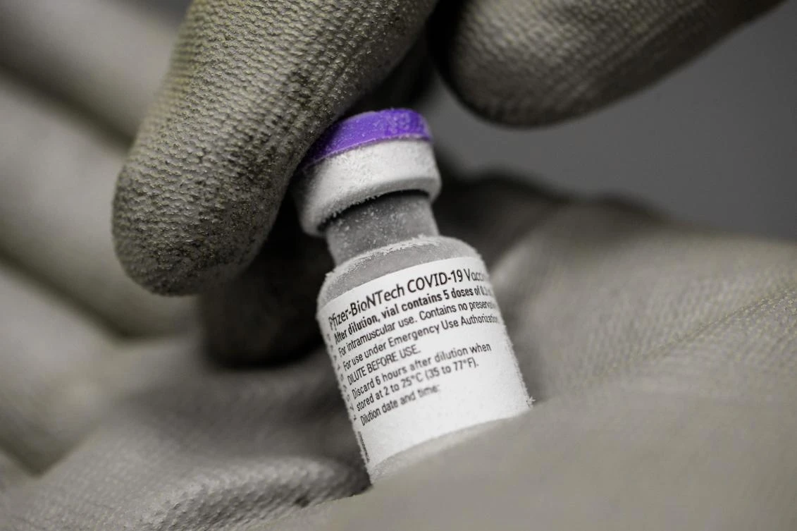 A pharmacist holds a phial of the undiluted Pfizer-BioNTech vaccine for Covid-19, stored at -70 ° in a hospital freezer in France. (File/AFP)