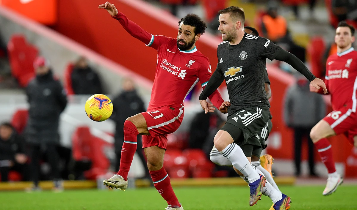 Manchester United's Luke Shaw vies for the ball with Liverpool's Mohamed Salah, left, during the English Premier League match in Liverpool on Sunday. (AP)