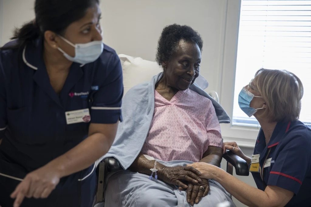 Josephine Faleye (C), 80, is prepared to receive the Pfizer-BioNTech Covid-19 vaccine at the Royal Free hospital in London on December 8, 2020 at the start of the UK's biggest ever vaccination programme. (File/AFP)