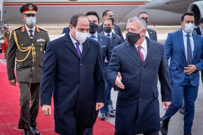 Egyptian President Abdel Fattah El-Sisi, left, is met by Jordan’s King Abdullah on his arrival in Amman. (Twitter/@RHCJO)