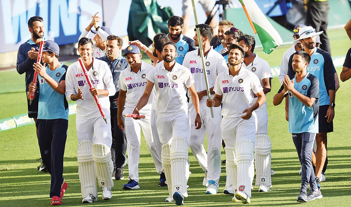 Indian players celebrate winning on day five of the fourth test match between Australia and India at the Gabba in Brisbane on Tuesday. (Reuters)