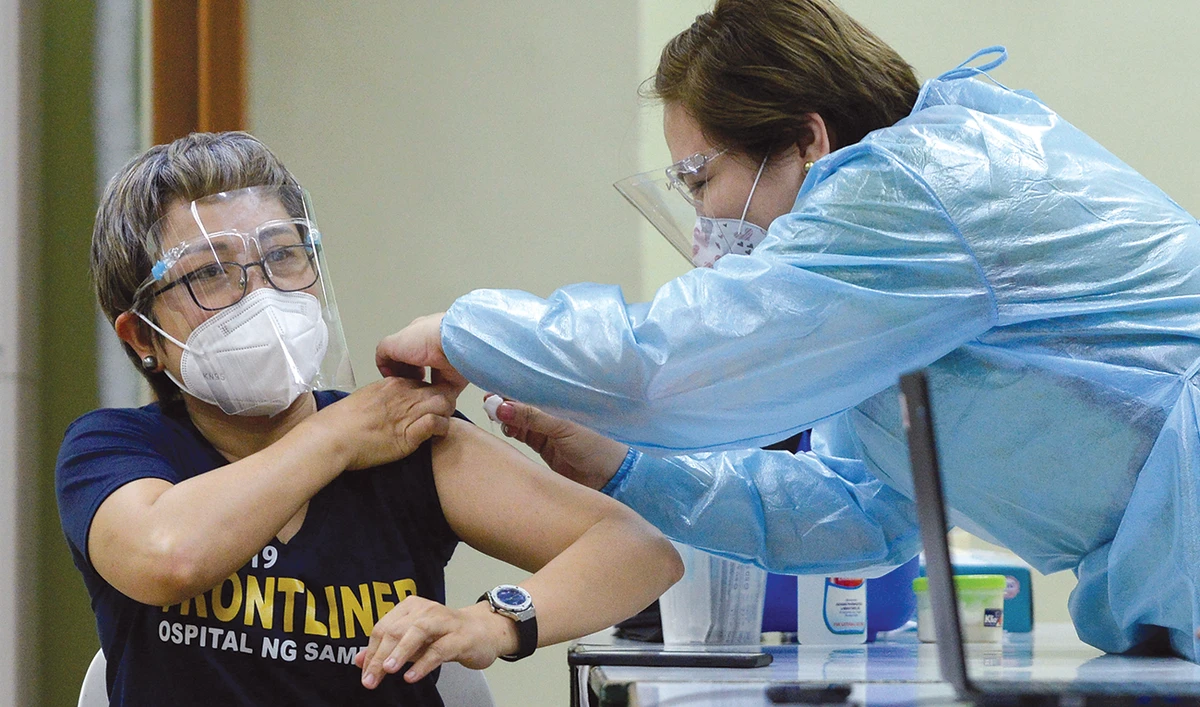 A health worker conducts a mock vaccination during a simulation exercise for the coronavirus disease (COVID-19) vaccination activities, in Manila on Tuesday. (Reuters)
