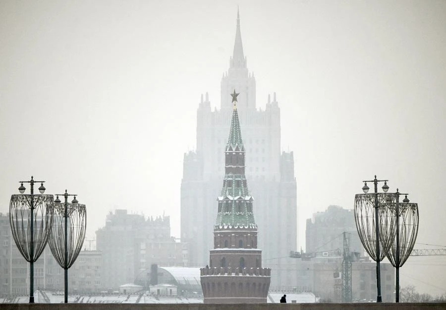 A man walks along a bridge in front of a Kremlin tower and the Russian Foreign Ministry building on the background in downtown Moscow on January 12, 2021. (File/AFP)