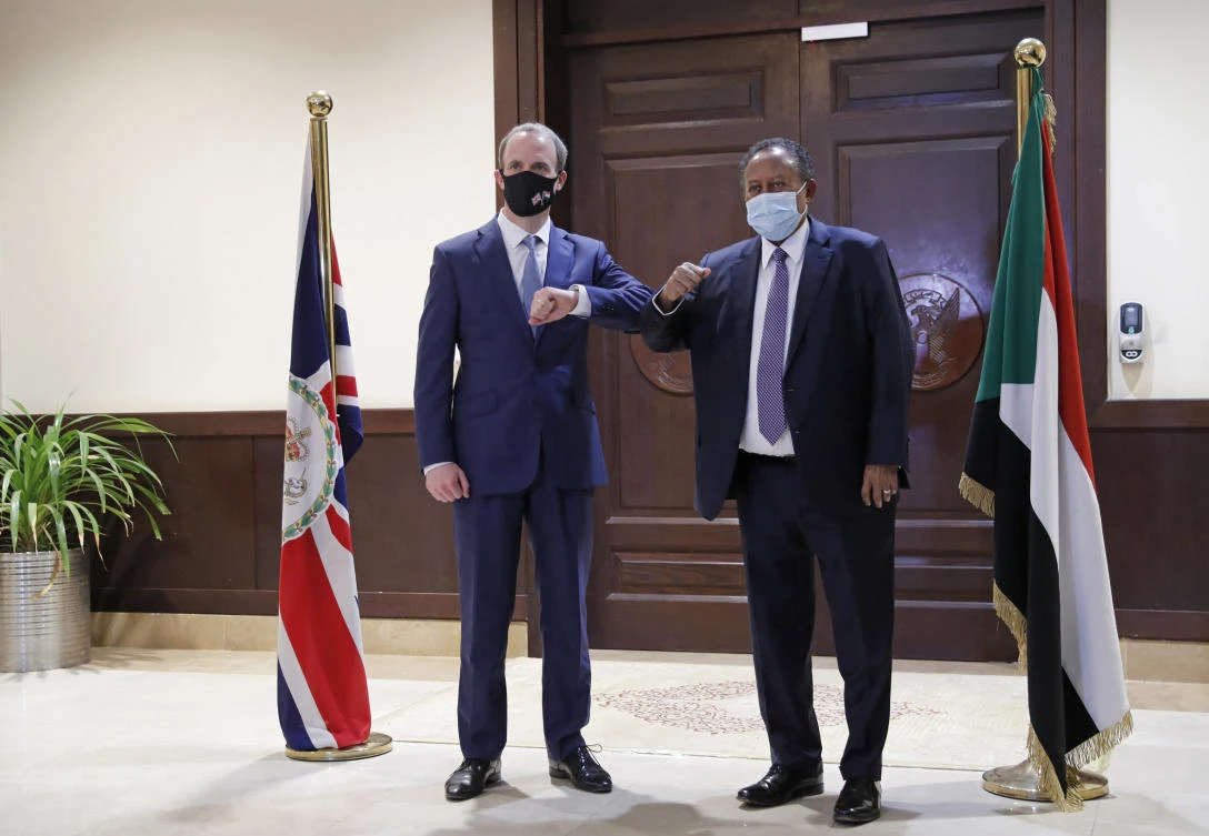 Sudanese Prime MInister Abdullah Hamdok, right, bumps elbows with British Foreign Secretary, Dominic Raab in the Cabinet Building, in Khartoum, Sudan, Thursday, Jan. 21, 2021. (AP)
