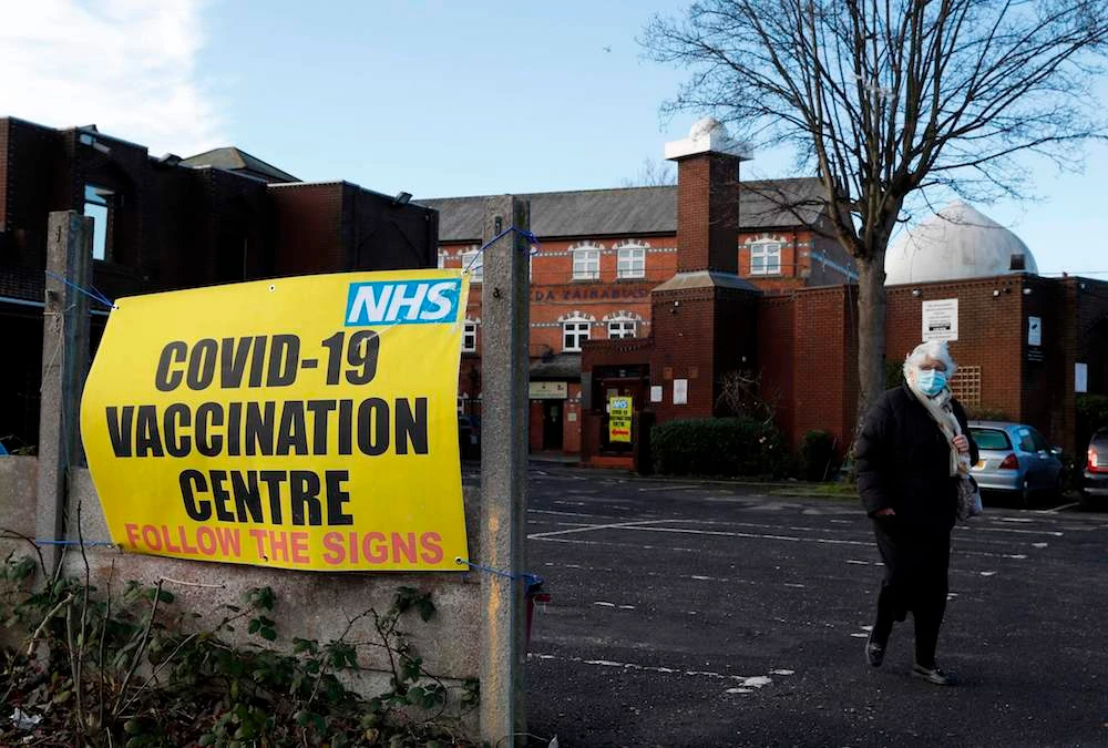 A woman leaves after receiving the Oxford/AstraZeneca Covid-19 vaccine at the Al-Abbas Islamic Centre, which has been converted into a temporary vaccination centre in Birmingham, central England on January 21, 2021. (AFP)