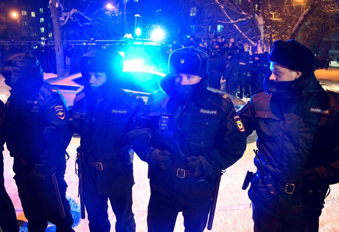 Police officers stand guard while waiting for a wagon carrying opposition leader Alexei Navalny in Khimki, outside Moscow. (AFP)