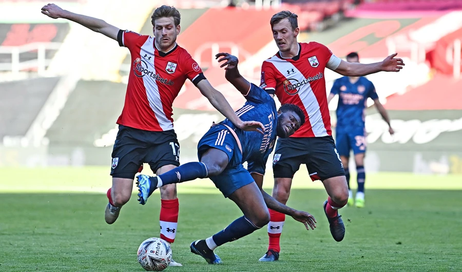 Arsenal’s midfielder Thomas Partey vies with Southampton’s midfielders Stuart Armstrong and James Ward-Prowse during Saturday’s match. (AFP)