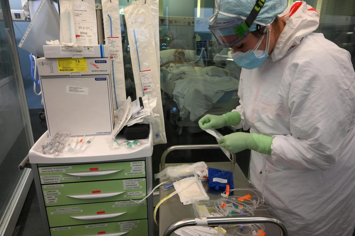 A health care worker attends to a patient at the Covid-19 Intensive Care Unit (ICU) of the Hospital Del Mar in Barcelona on January 20, 2021. (AFP)