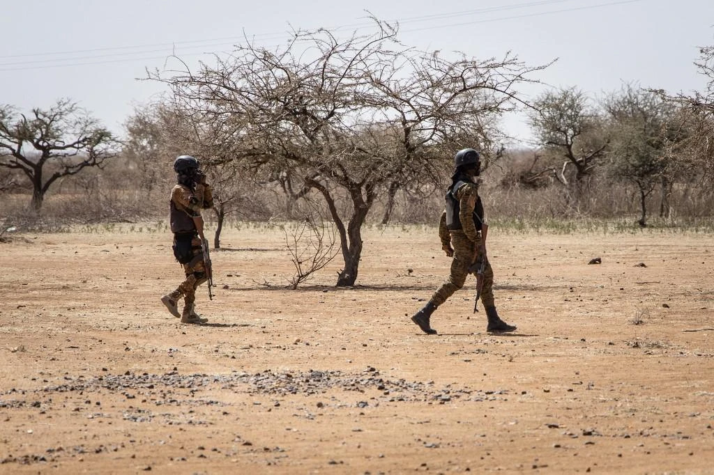 Burkina Faso soldiers patrol at entrance of the Goudebo refugee camp for Malian refugees, in Dori on Feb. 3, 2020. (File/AFP)