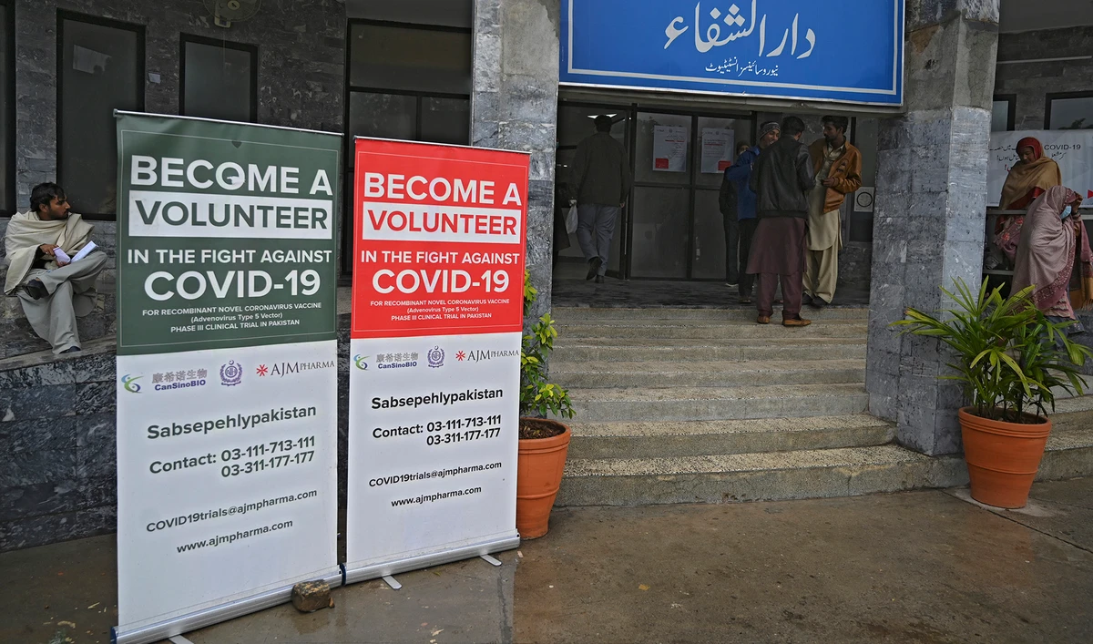 In this picture taken on Nov. 25, 2020, volunteers wait to be administered the Chinese-made vaccine for the Covid-19 coronavirus, the first ever Phase 3 clinical trial for any vaccine in Pakistan, at a hospital entrance in Islamabad. (AFP/File)