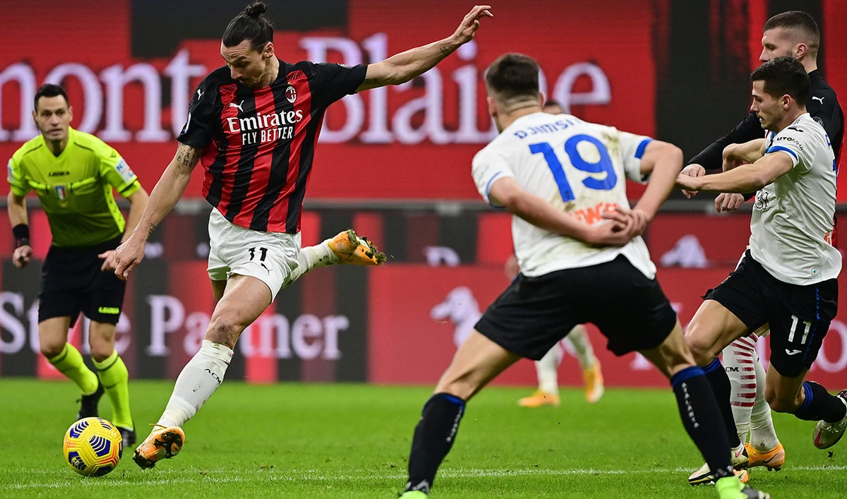 AC Milan’s forward Zlatan Ibrahimovic, left, shoots on goal during the Italian Serie A football match with Atalanta Bergamo at the San Siro stadium in Milan. (AFP)