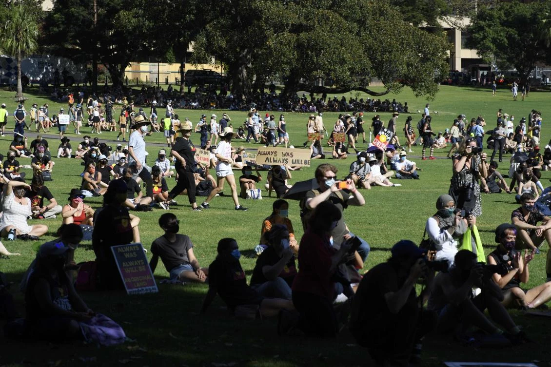 Thousands of people gathered at a central Sydney park, above, in defiance of police threats of fines and arrests for breaching a 500-person limit on public gatherings. (AFP)