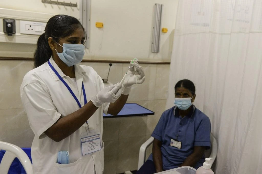 A medical worker prepares to inoculates a frontline staff with a COVID-19 vaccine at KIMS hospital in Hyderabad on Jan. 26, 2021. (AFP)