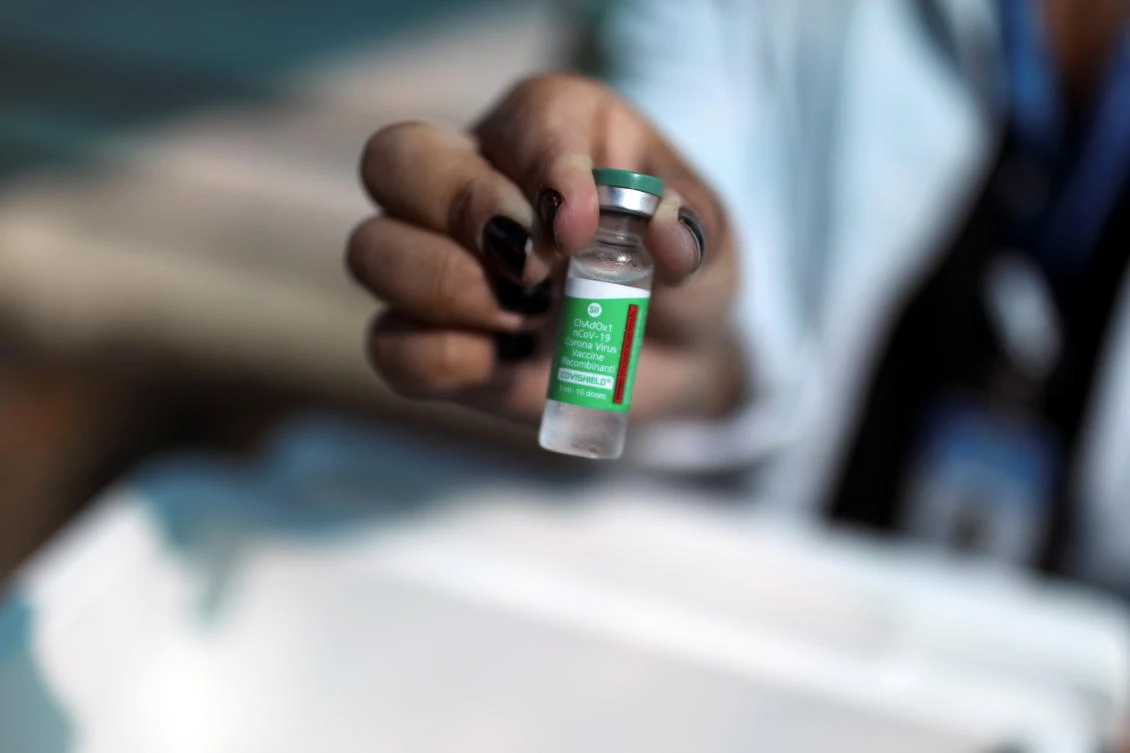 A healthcare worker holds a vial of the AstraZeneca/Oxford coronavirus disease (COVID-19) vaccine at a public hospital in Rio de Janeiro, Brazil, January 27, 2021. (Reuters)
