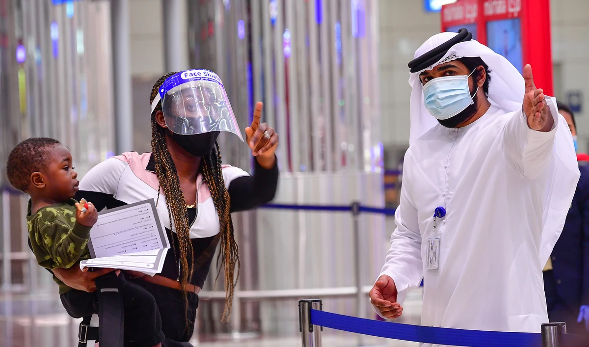 A tourist receives instruction at Dubai airport in the United Arab Emirates on July 8, 2020. (AFP/File)