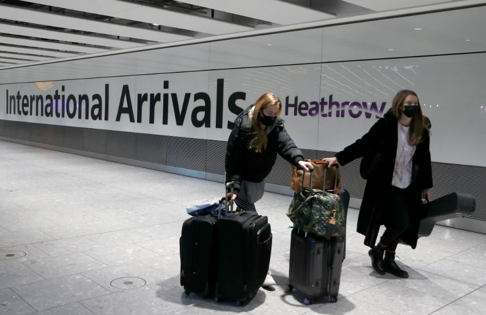 Travelers arrive at London's Heathrow Airport in London in this Jan. 17, 2021 photo. (AP Photo/Frank Augstein, File)
