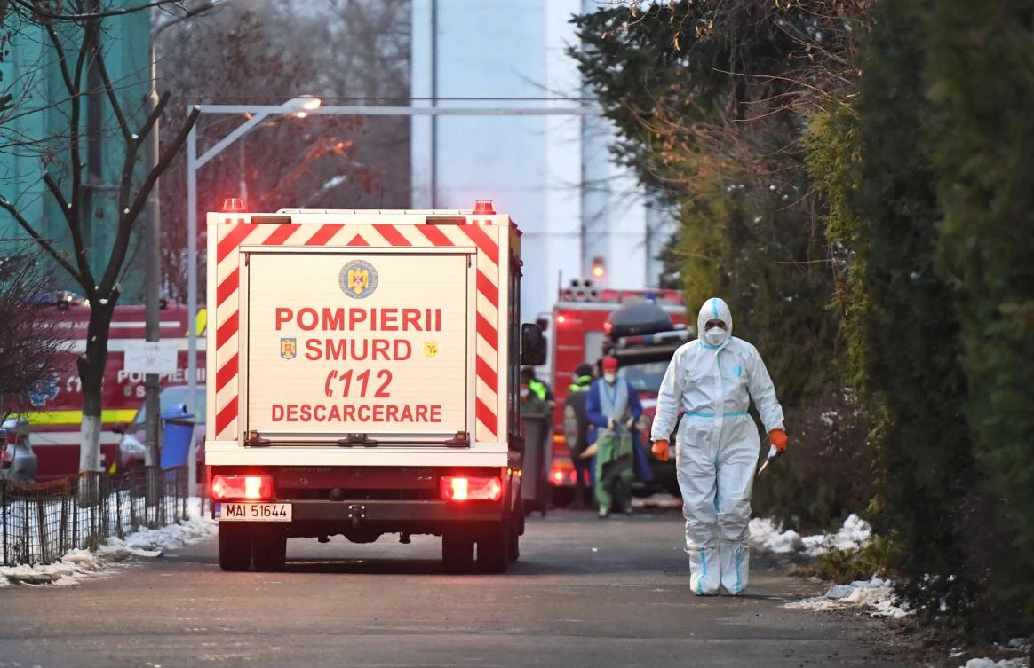 Firefighters work in the courtyard of the Matei Bals infectious diseases hospital's burned pavilion in Bucharest on January 29, 2021 where at least four people died after a fire broke out in Romania's main hospital treating COVID-19 patients. (AFP)