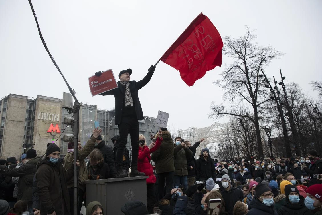 A demonstrator waves a red flag and holds a banner that reads: ‘I’m for Navalny,’ at a protest supporting jailed opposition leader Alexei Navalny in Moscow, Russia, Jan. 23, 2021. (AP Photo)