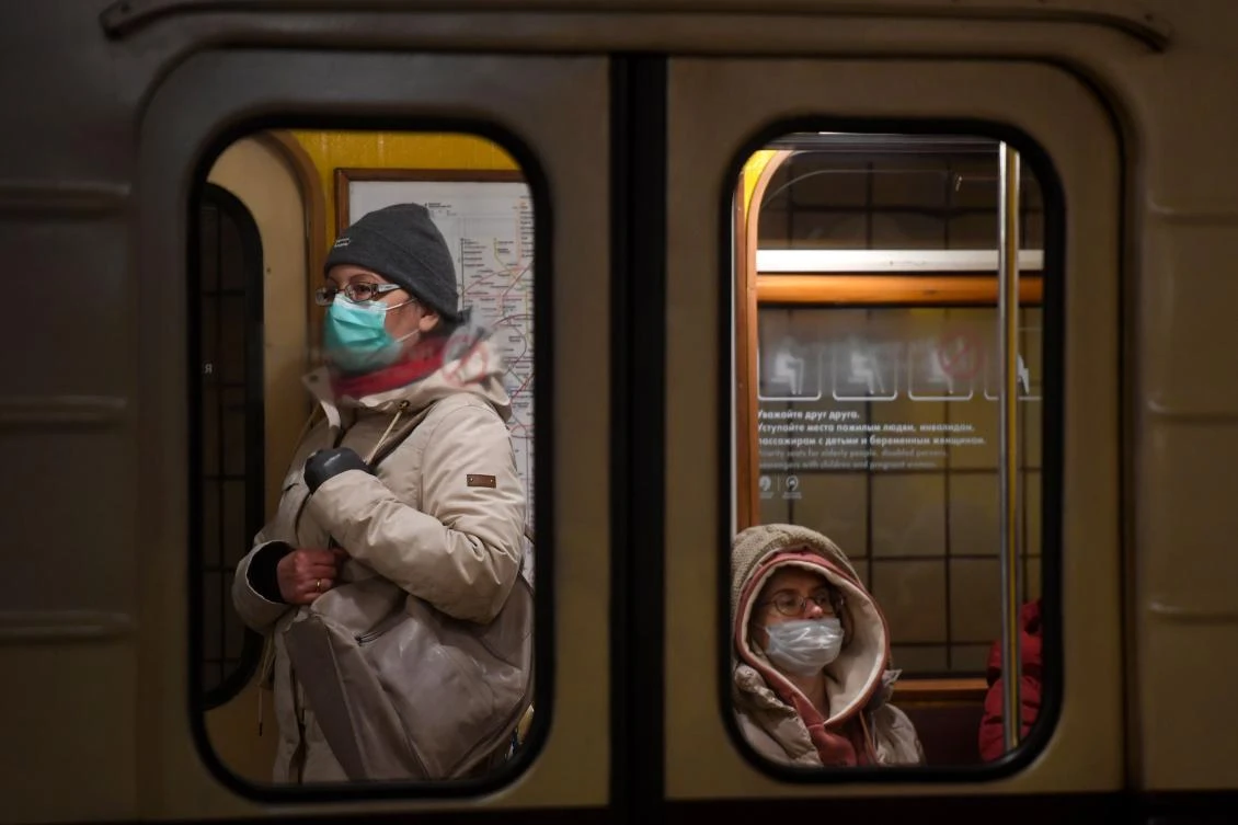 Women wearing face masks to protect against the coronavirus disease ride on a metro train in Moscow on January 28, 2021. (AFP)