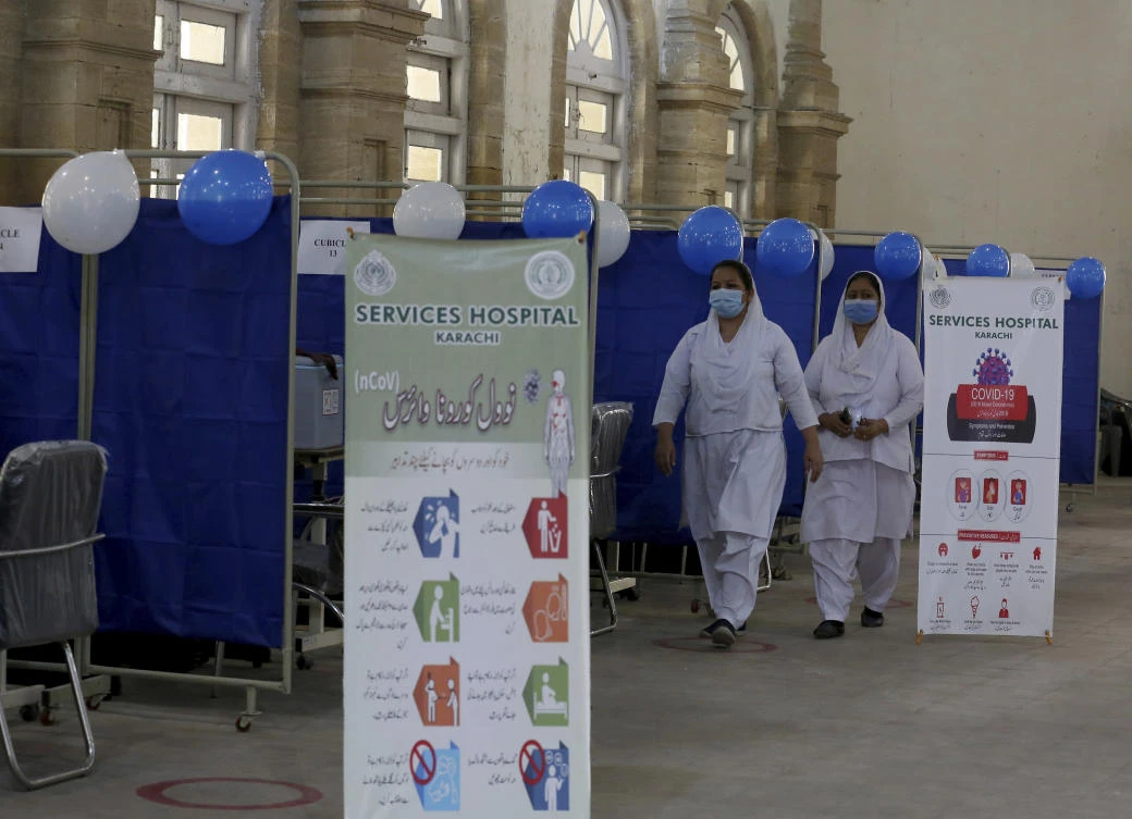 Nurses walk in a center newly setup for upcoming COVID-19 vaccination, in Karachi, Pakistan, Saturday, Jan. 30, 2021. (AP)