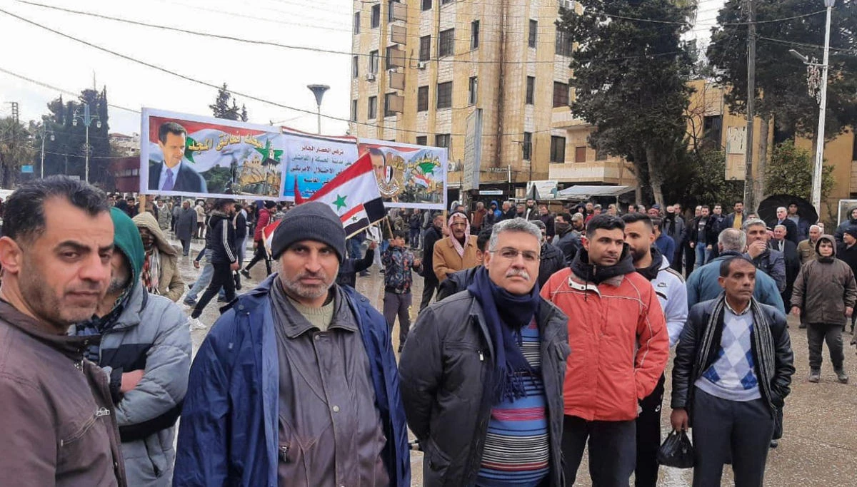 A handout picture released by the official Syrian Arab News Agency (SANA) shows Syrian pro-government protesters rallying in the northeastern Kurdish-controlled city of Hasakeh, on January 31, 2021. (AFP/ SANA)