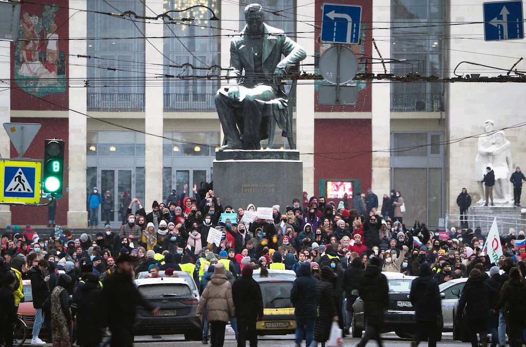 Protesters gather near a monument of Russian playwright Alexander Griboyedov during a protest against the jailing of opposition leader Alexei Navalny in St. Petersburg, Russia, Sunday, Jan. 31, 2021. (AFP)
