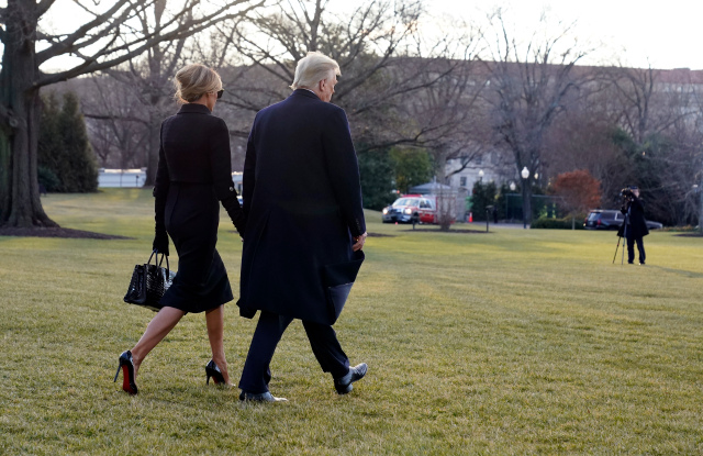 President Donald Trump and First Lady Melania Trump walk to board Marine One on the South Lawn of the White House. (AP Photo)