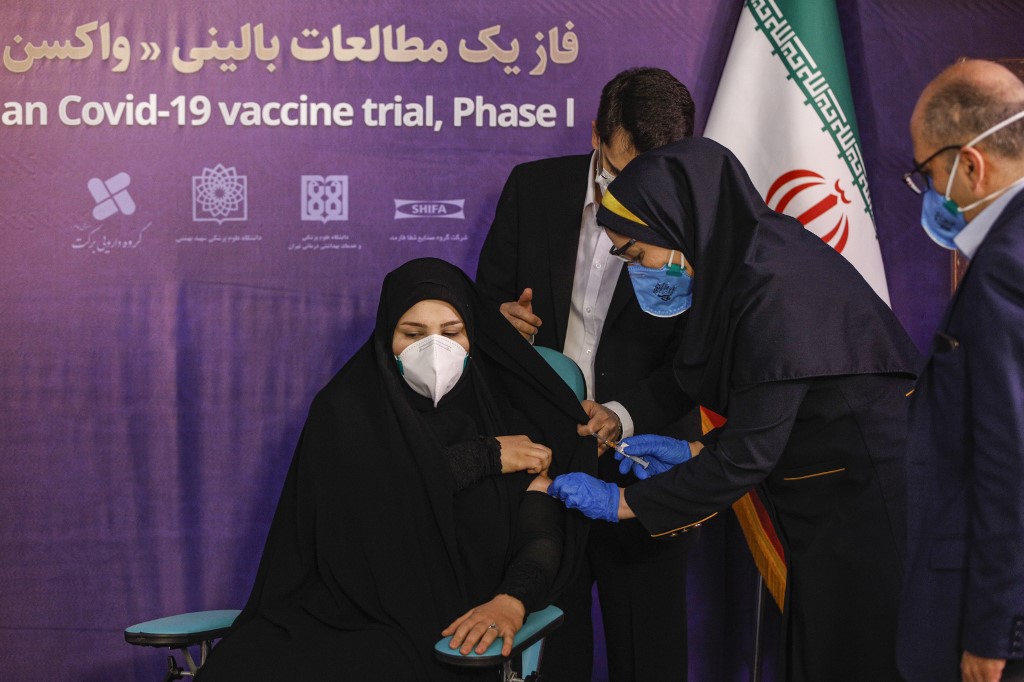 A woman receives an injection during the first trial phase of a locally-made Iranian vaccine for COVID-19 in Tehran. (File/AFP)